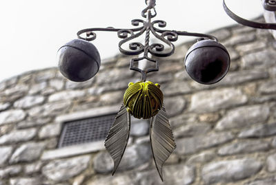 Low angle view of decoration hanging against wall