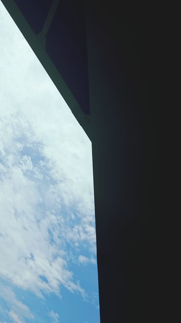 low angle view, architecture, built structure, sky, building exterior, window, cloud, cloud - sky, day, no people, blue, building, outdoors, sunlight, directly below, copy space, high section, silhouette, nature