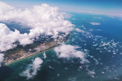 Aerial view of sea and landscape against sky