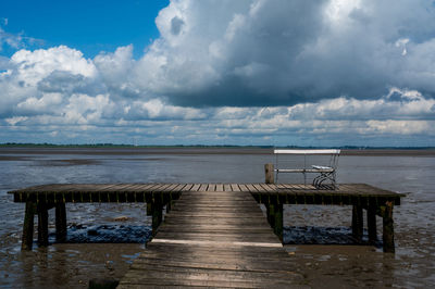 A bench on a jetty on the wadden sea