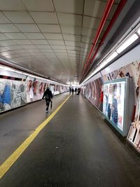 Rear view of people on illuminated ceiling