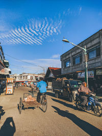 Street amidst buildings in city against sky