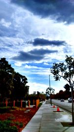 Empty road against cloudy sky