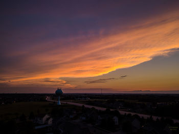 Scenic view of landscape against orange sky