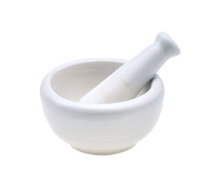 Close-up of mortar and pestle against white background