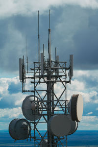 Low angle view of communications tower against sky