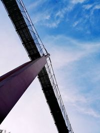 Low angle view of crane against sky