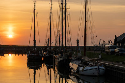 Sailboats in marina at sunset