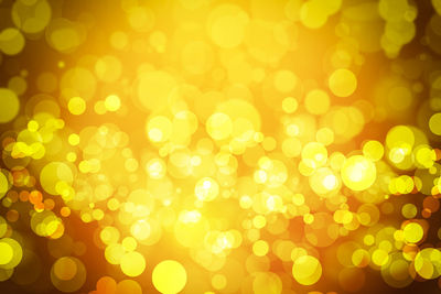 Defocused image of illuminated yellow lights