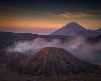 View of volcanic landscape against sky during sunset