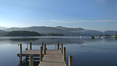 Pier over lake against sky