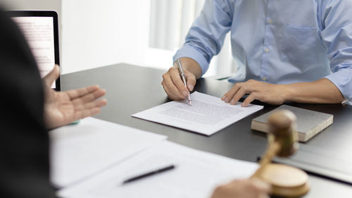 Midsection of business colleagues working at office