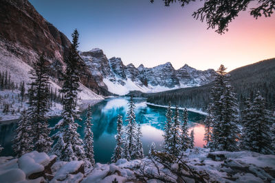 Scenic view of snowcapped mountains against sky during sunset