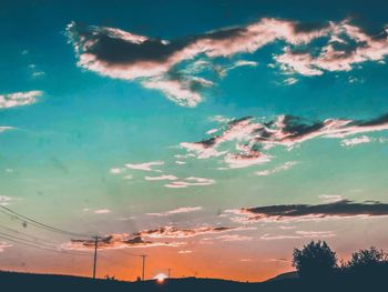 Low angle view of silhouette trees against sky during sunset