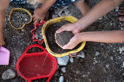 High angle view of hands holding girl