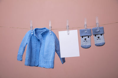 Close-up of clothes drying against blue wall