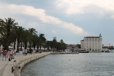 View of calm beach against cloudy sky