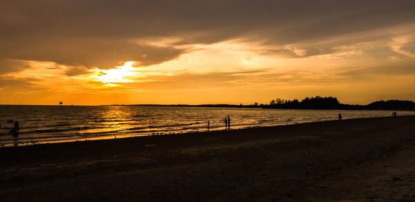 Scenic view of beach against sky during sunset