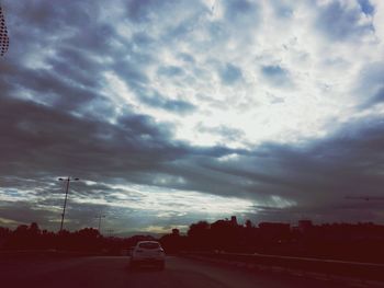 View of road against cloudy sky