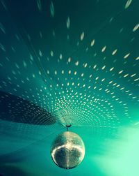 Reflection of lights on ceiling from disco ball at nightclub
