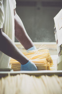 Midsection of man holding raw pastas