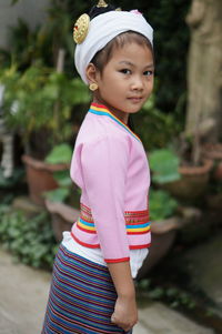 Portrait of smiling girl standing outdoors