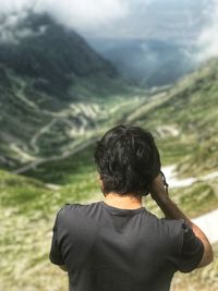 Rear view of man looking at mountains