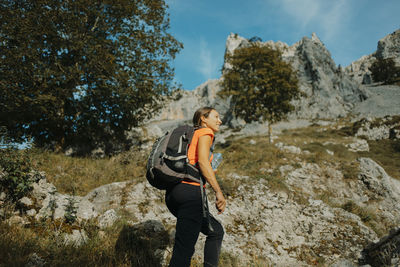 Side view of man standing on rock