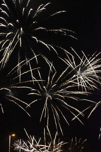 Low angle view of firework display at night