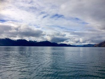 View of calm sea against cloudy sky