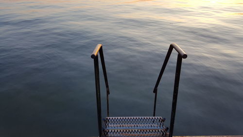 High angle view of metallic ladder in lake