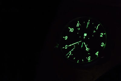 Close-up of clock on black background