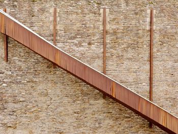 Metal railing against brick wall