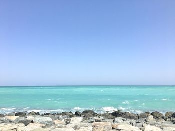 Scenic view of sea against clear blue sky