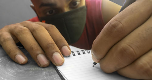 Close-up of person hand holding book