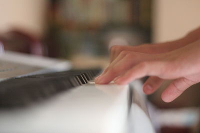 Cropped hands playing piano