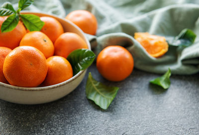 Fresh citrus fruits tangerines, oranges on a concrete background