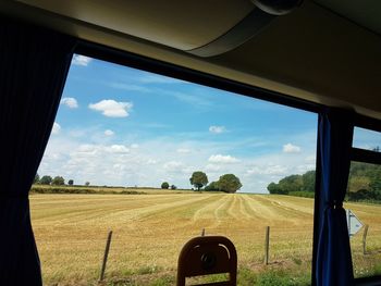 Scenic view of field seen through window