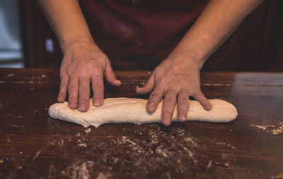 Close-up of person preparing food on table