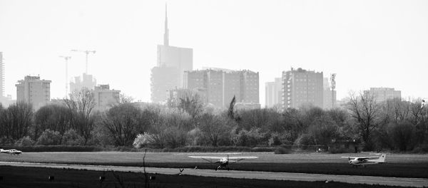 City by buildings against clear sky