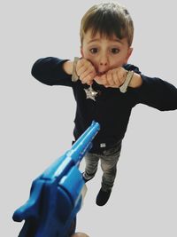 Portrait of cute boy against white background