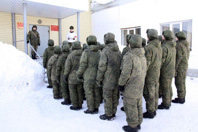 Rear view of people in snow