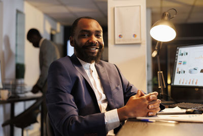 Portrait of businessman using digital tablet in office