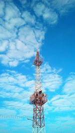 Low angle view of communications tower against blue sky