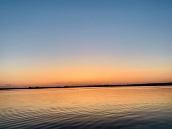 Scenic view of sea against clear sky at sunset