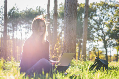 Woman using laptop at park