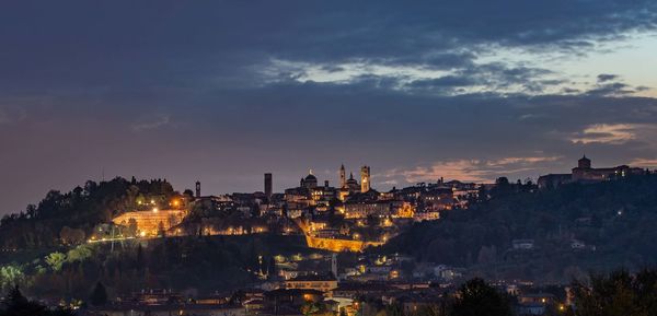 High angle view of buildings in city at sunset