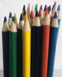 Close-up of colored pencils against white background