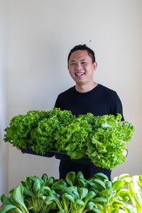 Portrait of a smiling young man holding food