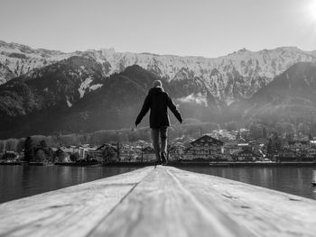 Rear view of woman standing on mountain